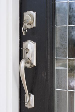 key on a keychain in the lock of a front doorの写真素材
