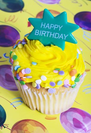 Delight colored cupcake on colorful background of balloonsの写真素材