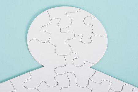 A puzzle in shape of a human on blue backgroundの写真素材