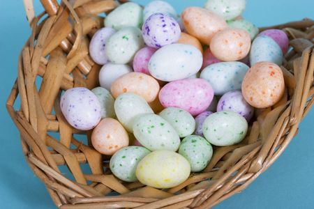 pastel easter eggs - jelly beans in a wooden basket 