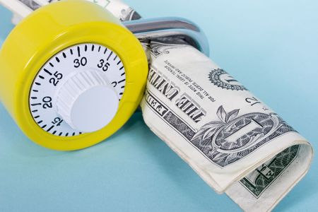 Yellow combination lock with one dollar billsの写真素材