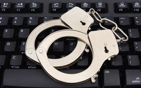 Handcuffs on computer keyboard for internet security