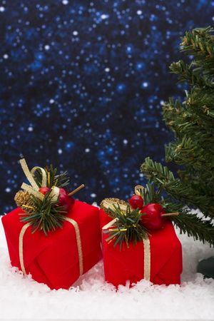 Christmas tree with gifts with a snowy night background