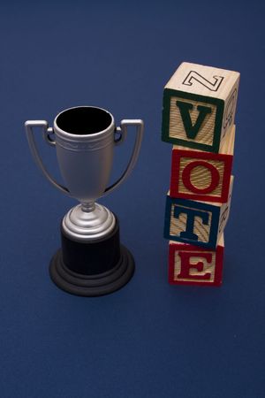 Trophy with vote alphabet blocks