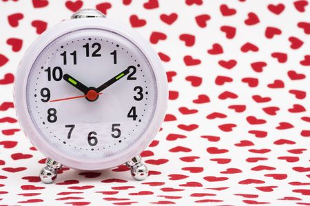 Clock on white and heart background