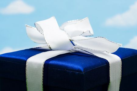 Close-up of a blue gift on sky backgroundの写真素材