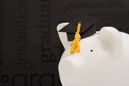 Piggy bank with graduation cap cost of educationの写真素材