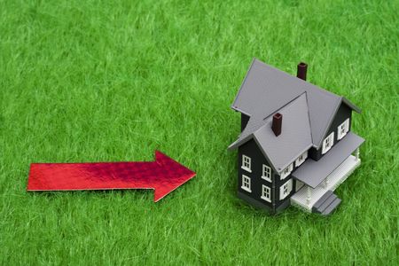 Model house with arrow pointing to it