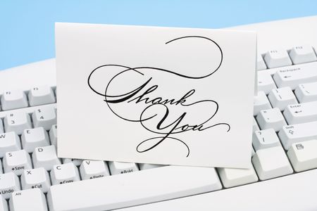 Thank you card on a white keyboardの写真素材