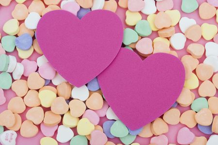 Candy hearts with two blank paper heartsの写真素材