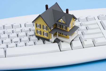Model house sitting on a white keyboardの写真素材