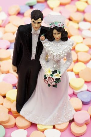 Wedding cake topper on a candy heartsの写真素材