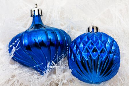 Blue glass ball ornaments on white garland background, Christmas backgroundの写真素材