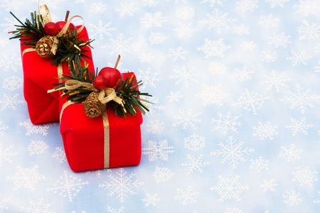 Two red wrapped presents on snowflake background, Christmas presents