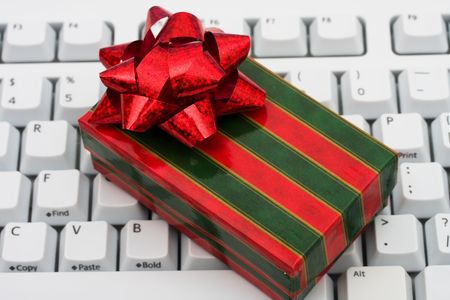 Red Christmas presents on grey computer keyboard, online Christmas shoppingの写真素材