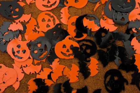 Orange and black pumpkins, bats, and moons on brown backgrounds, happy Halloweenの写真素材