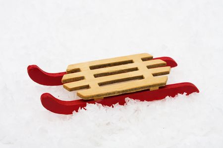 Wooden sleigh sitting on snow, winter funの写真素材