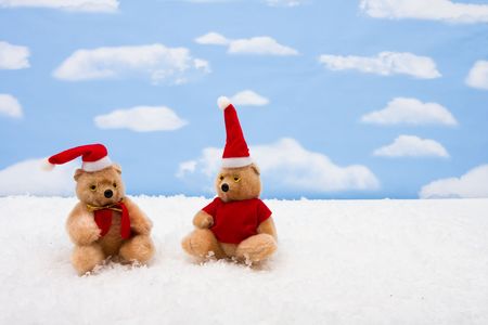 Stuffed bears wearing Santa hats on sky background, Christmas bearsの写真素材