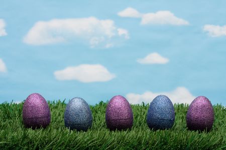 Purple and purple sparkle Easter eggs sitting on green grass background, Easter Eggs