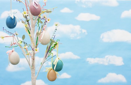 Colourful Easter eggs hanging from a tree on a sky background, Easter treeの写真素材