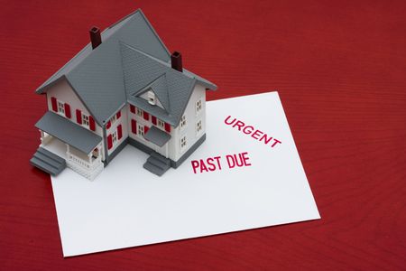 An overdue bill beside a house on red background, overdue mortgage