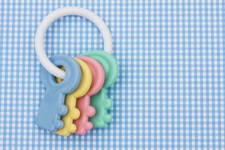 Colourful baby rattle on a blue background, baby rattleの写真素材