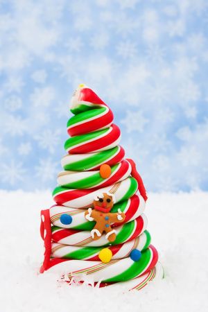 Decorated candy Christmas tree on snowflake background, candy Christmas treeの写真素材