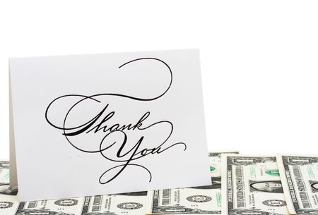 A thank you card sitting on dollar bills isolated on white background, thank youの写真素材