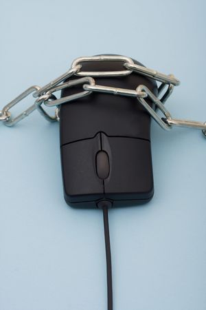 A computer mouse with a metal chain sitting on a blue background, online purchaseの写真素材