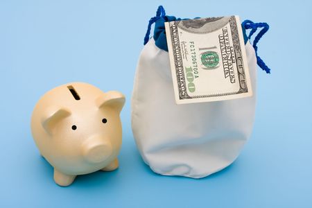 A piggy bank with a bag of money and one hundred dollar bill on a blue background, piggy bankの写真素材