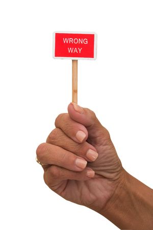 Hands holding a red wrong way sign isolated on a white background, wrong wayの写真素材