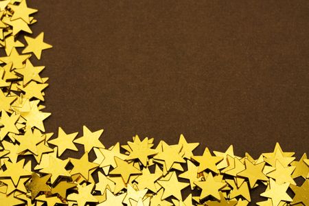 Gold stars making a border on a brown background, gold star borderの写真素材