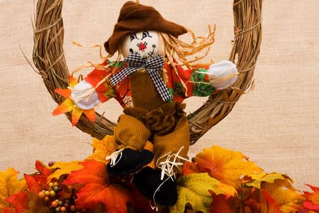 Fall leaves with a scarecrow on a beige background, fall borderの写真素材