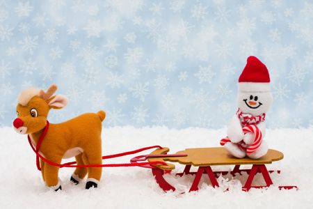 Evergreen trees sitting with a wooden sleigh with a blue snowflake background, Winter timeの写真素材