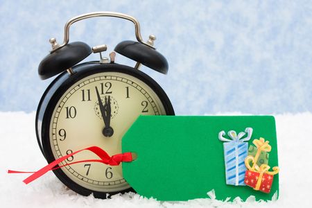 A retro clock with a blank gift tag snowflake background, winter time