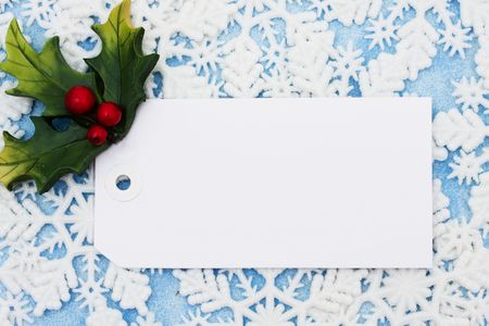 Blank gift tag on a snowflake backgroundの写真素材