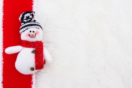 A snowman with a red ribbon on a white backgroundの写真素材