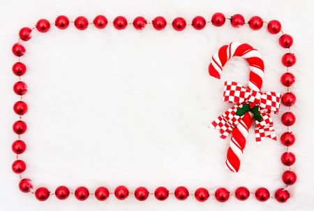 A candy cane with a beaded border on a white background