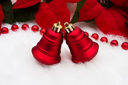 A set of red bells with poinsettia flowers on a white backgroundの写真素材