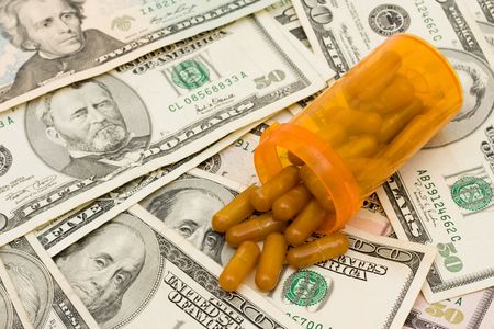 A prescription bottle with pills on a money background, medication costsの写真素材