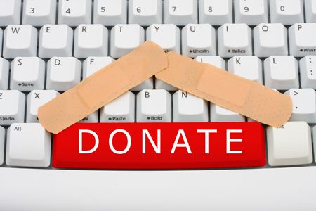 The word donate in red on a computer keyboard, Online donation