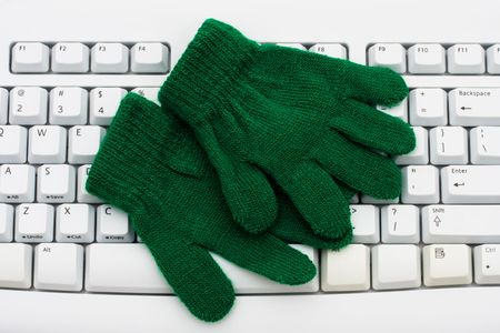 A pair of blue gloves on a computer keyboard, Get your weather reports onlineの写真素材