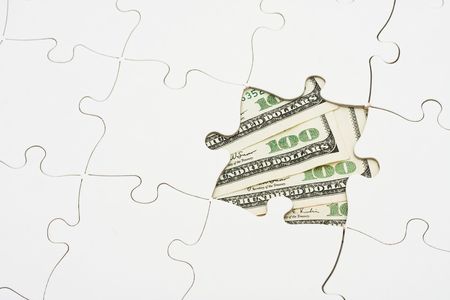 White puzzle on one hundred dollar bill, solving money problemsの写真素材
