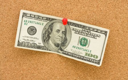 A one hundred dollar bill tacked to a corkboard, Getting Cashの写真素材