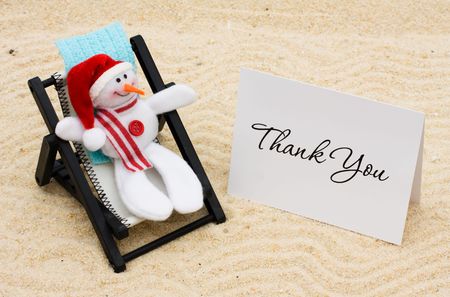 A lounge chair with snowmen on a sand background, Thankful for Vacation Timeの写真素材