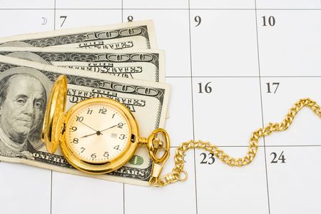 A gold pocket watch with cash on a white calendar background, Time to retireの写真素材