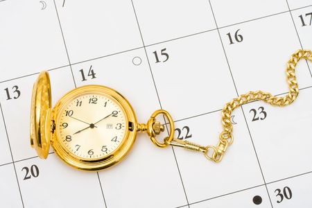A gold pocket watch on a white calendar background, Time to retireの写真素材