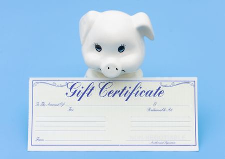 A piggy bank sitting with a gift certificate on a blue background, Adding to your Savingsの写真素材