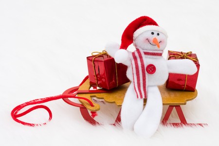 A snowman with a sleigh and presents on a white background, snowmanの写真素材