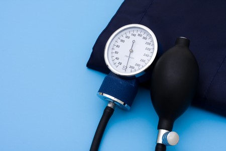 A blood pressure cuff on a blue background, medical careの写真素材